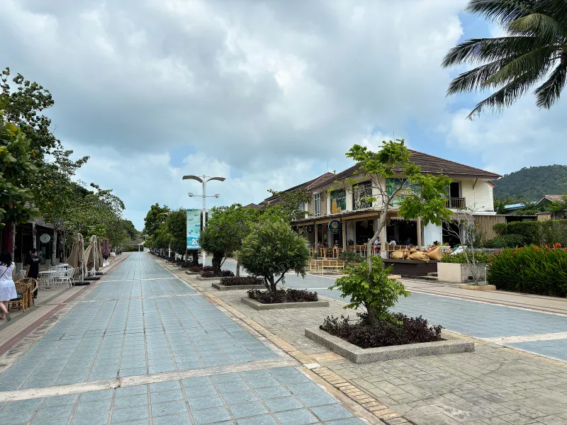 Landside walkway lined with cafes and palm trees near Samui International Airport, Koh Samui