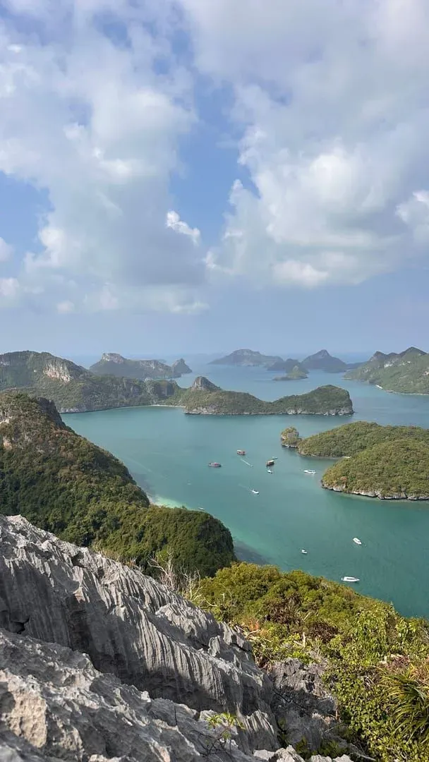 Speedboat carrying tourists through Ang Thong National Marine Park's limestone islands