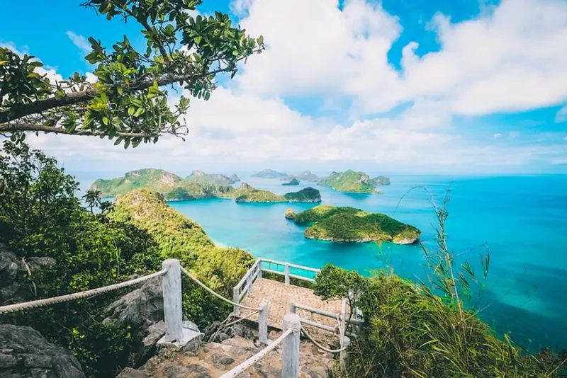 Tour boats crossing the channels between Ang Thong's limestone islands
