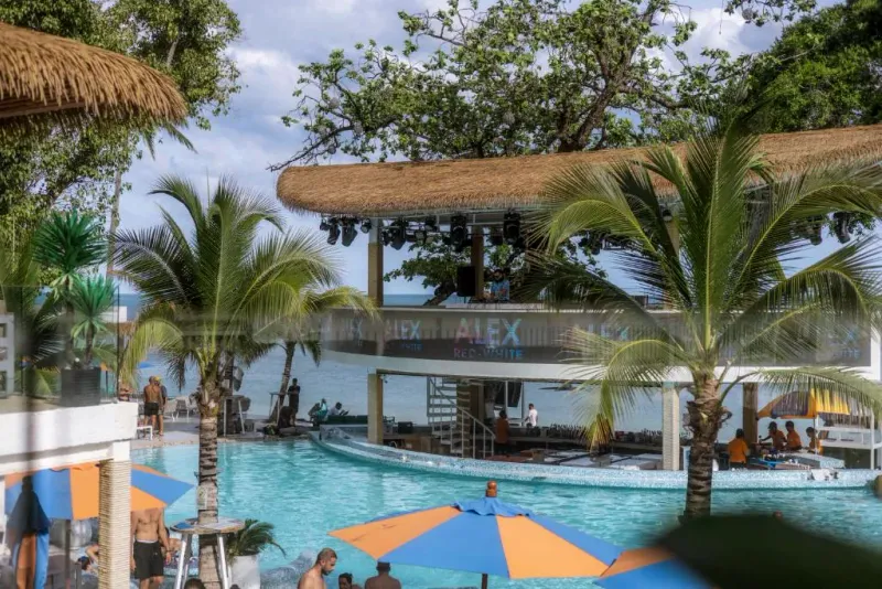 Guests relaxing on sun loungers at Ark Bar's pool deck on Chaweng Beach