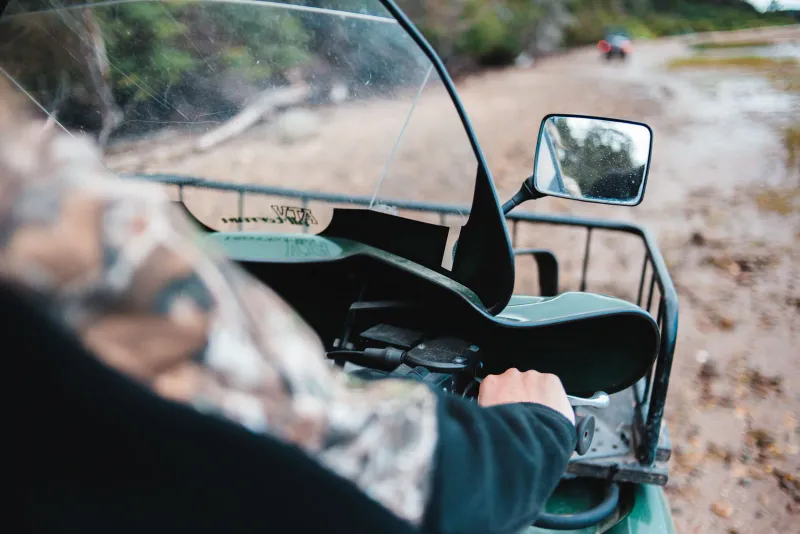 Close-up of a quad bike rider on a muddy off-road trail in Thailand