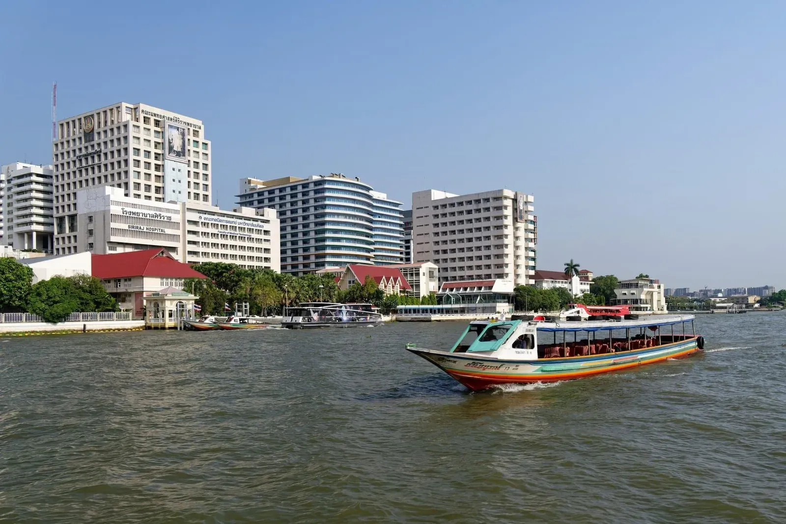 Chao Phraya riverboat cruising past the Bangkok skyline, illustrating the water transport that bookends this Thailand route