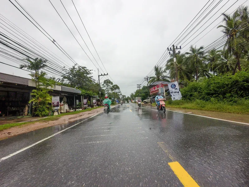 Coastal road through Maret village near Banyan Tree Samui, Koh Samui, lined with palms and small shops