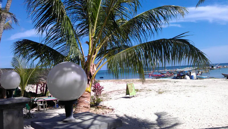White-sand cove with fishing boats near Banyan Tree Samui's stretch of coast at Lamai, Koh Samui