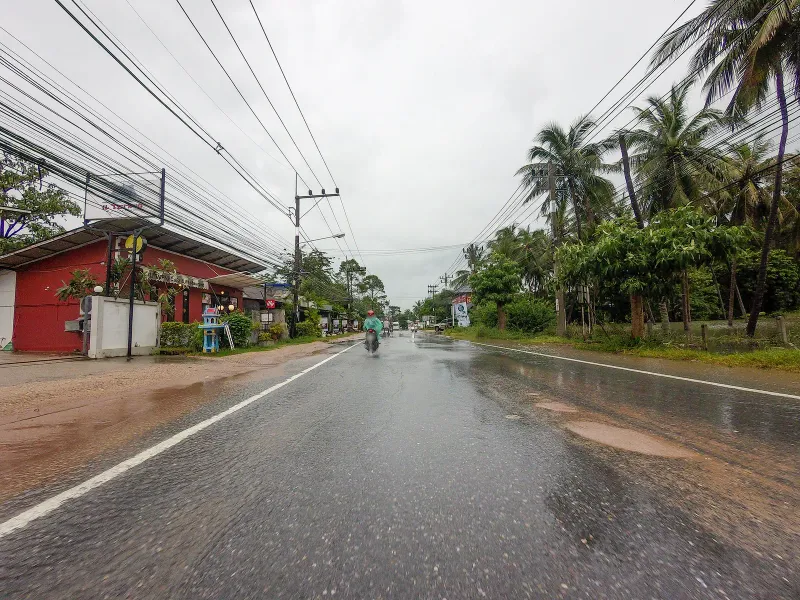 Wet season street scene on Route 4169 near the Banyan Tree Samui turnoff, Maret, Koh Samui