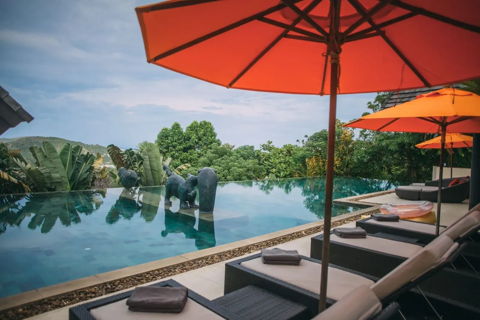 Poolside sun loungers at a Koh Samui condo development typical of long-term rental complexes