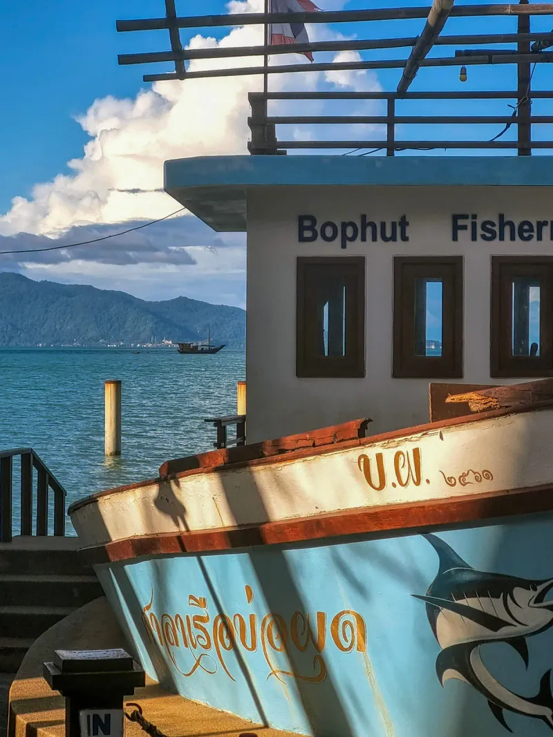 The Bophut Fisherman's Village signage on a boat-shaped structure by the pier, Koh Samui