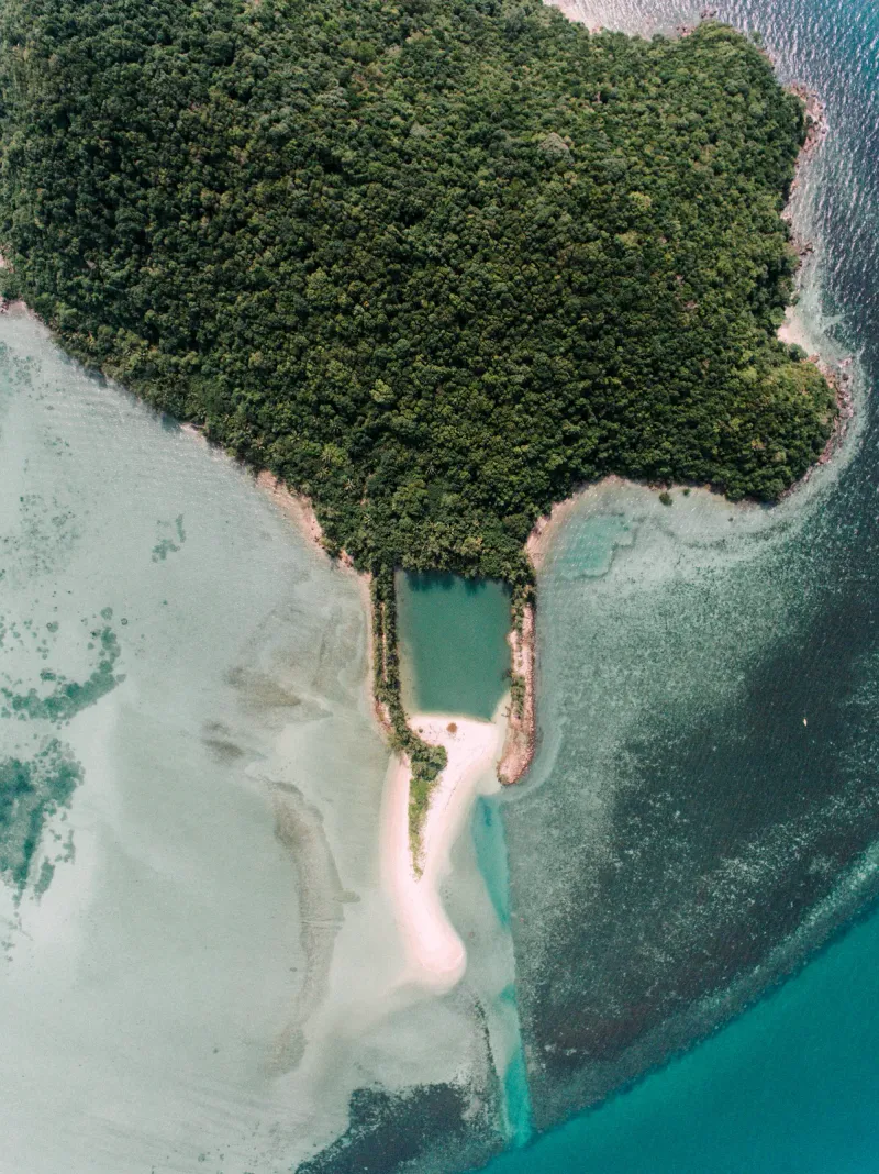 Aerial view of a tropical islet with a white sand cove near Choeng Mon, Koh Samui