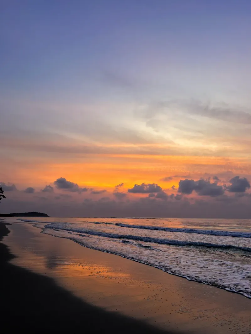 Silhouette of a visitor watching the sunset on north Chaweng Beach, Koh Samui
