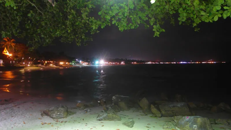Chaweng Beach Road lit up at night with crowds and lights