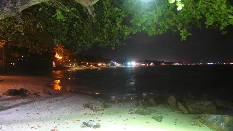 Nighttime scene of Chaweng Beach Road with lights and crowds during the Koh Samui festive season