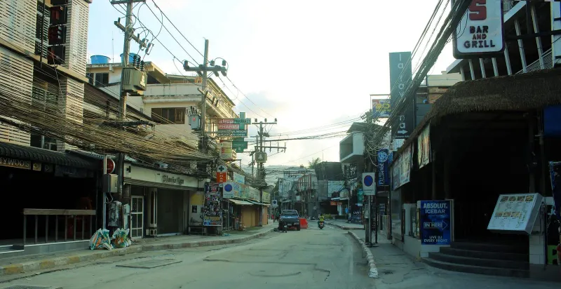 Street view of central Chaweng Beach Road lined with shops on Koh Samui