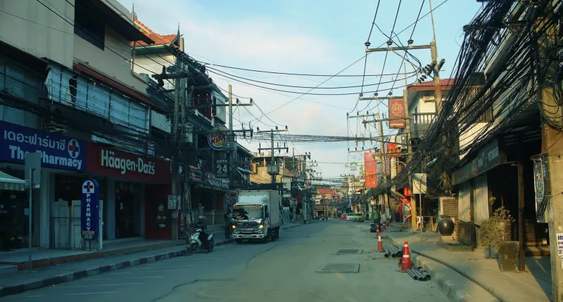 Traffic and scooters moving along the beach road in Chaweng, Koh Samui