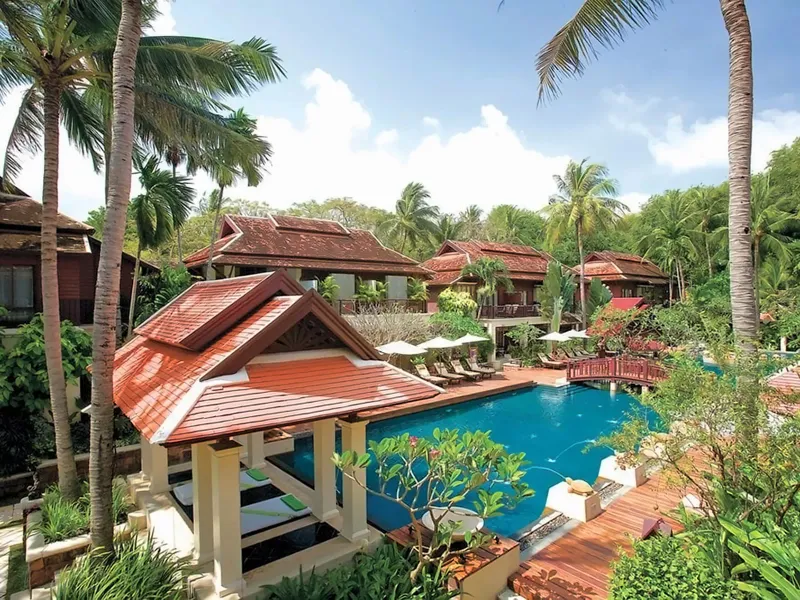 Piscine arrondie avec transats et palmiers au Chaweng Regent Beach Resort, Koh Samui