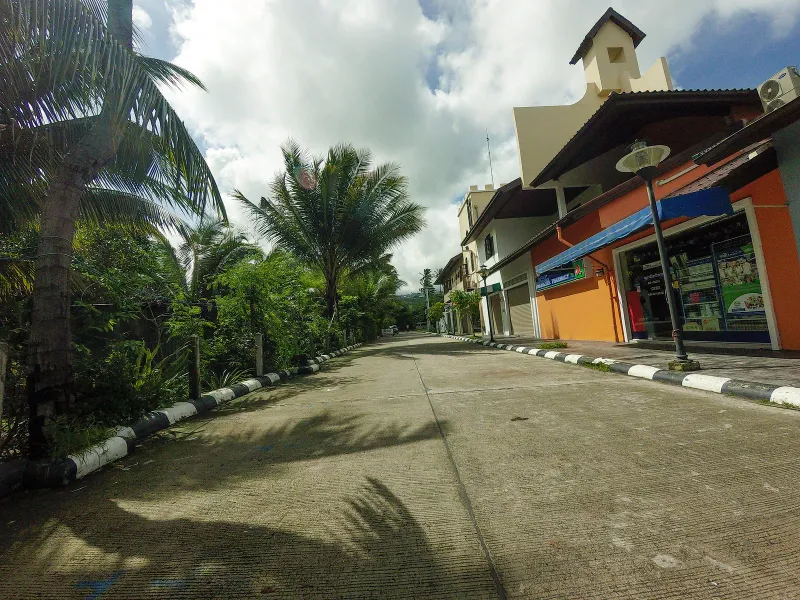 Fisherman's Village main road with shophouses and parked scooters, Bophut, Koh Samui
