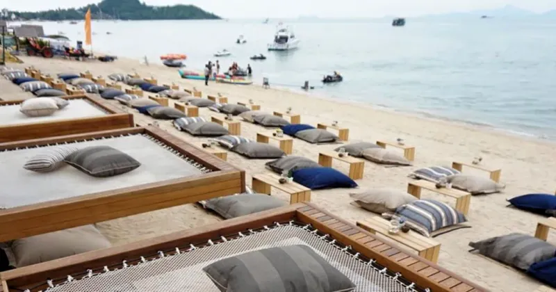 Coco Tam's thatched-roof bar and dining area beside Bophut Beach