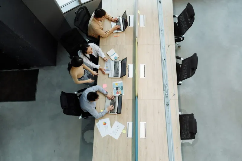 High angle view of remote workers on laptops in a modern coworking office setting