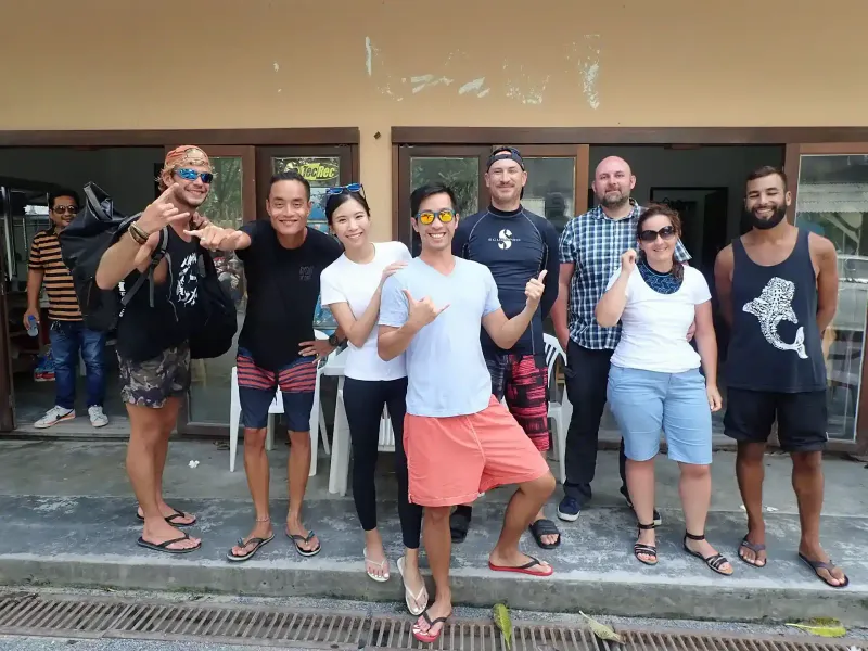 Discovery Divers' staff and guests posing together outside the dive shop