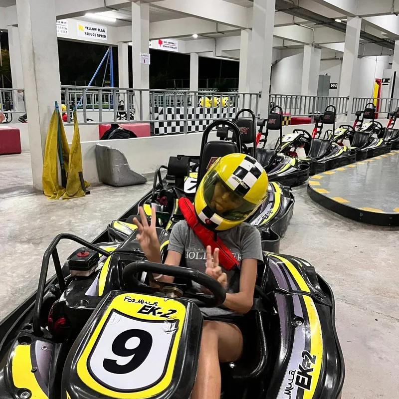 A young driver in a go-kart lined up on the grid at EasyKart Koh Samui's indoor-style track