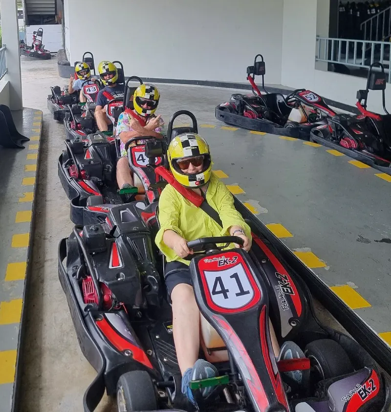 Drivers in helmets lined up in their go-karts at EasyKart Koh Samui