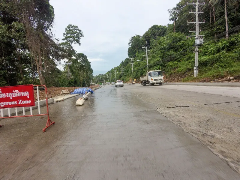 Hillside road bend with rocky outcrop near the Laem Yai headland, Koh Samui