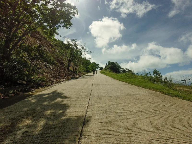 Hillside road above Koh Samui's northwest coast at sunset, near the Four Seasons Resort access route