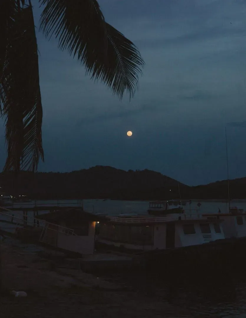 Boats moored at a Gulf of Thailand pier at night, similar to the party boats departing Koh Samui's piers for Haad Rin