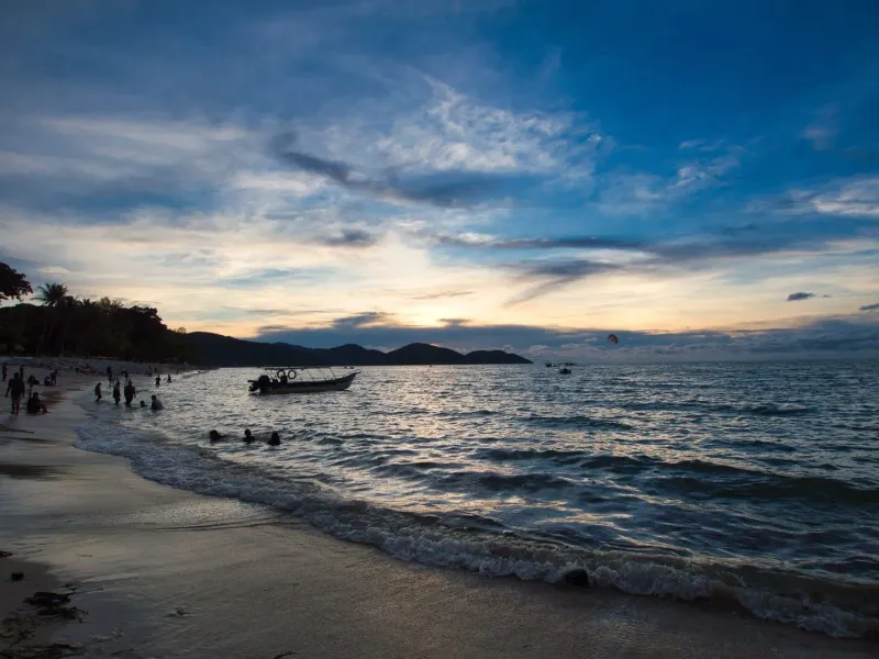 Silhouettes on a Gulf of Thailand beach at sunset before the full moon party crowd arrives