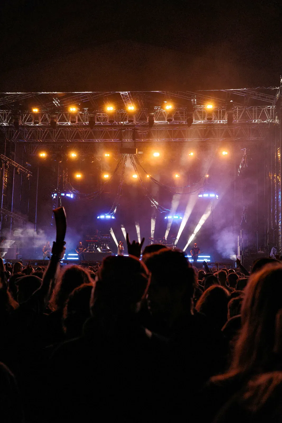 Stage lights and a crowd at a night festival