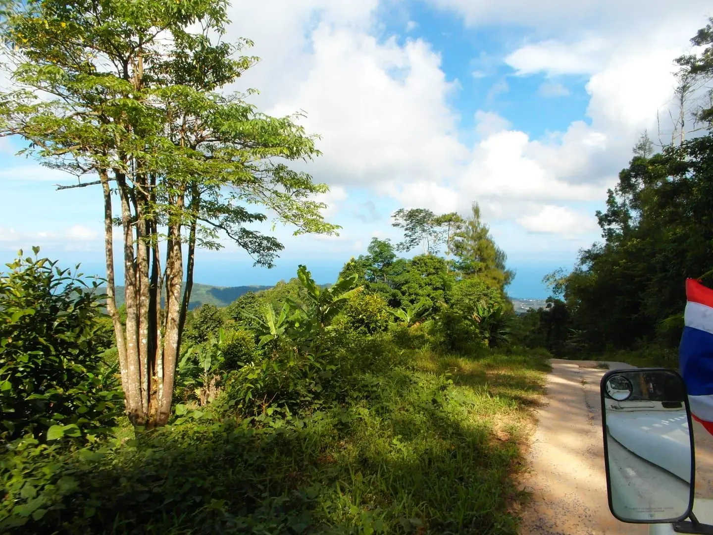 Coastline and jungle canopy from Koh Samui's interior hills, near Jungle Route 360, another ridge-road lookout