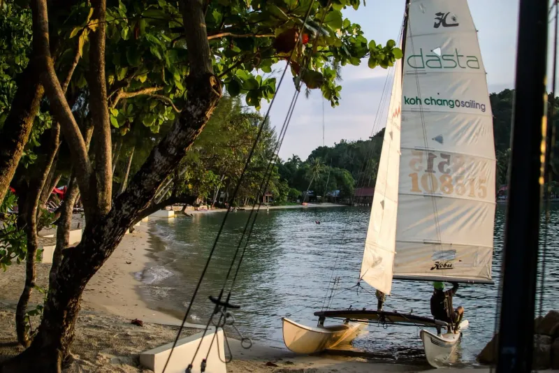 Small boat resting on a quiet beach, echoing the longtail crossings to Bottle Beach Koh Phangan