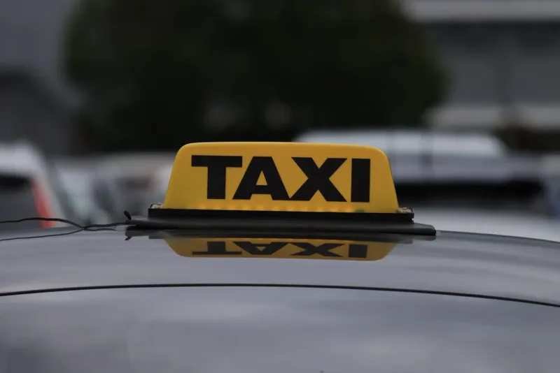 Yellow taxi sign on a car roof used for airport transfer pickups to Chaweng