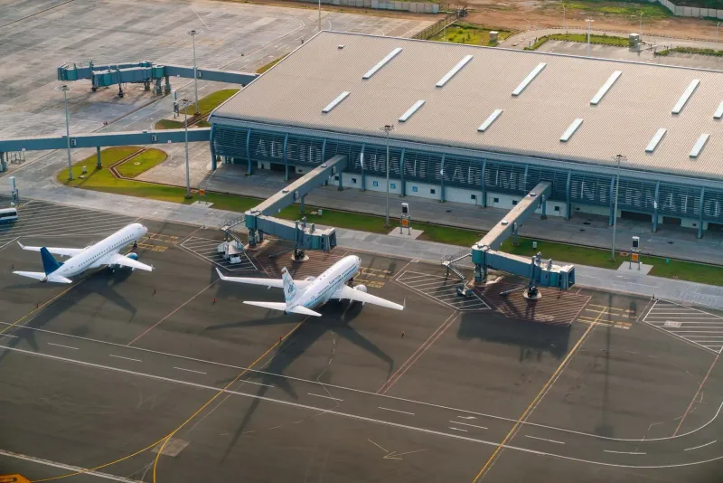 Aerial view of an island airport runway and terminal similar in scale to Koh Samui Airport USM