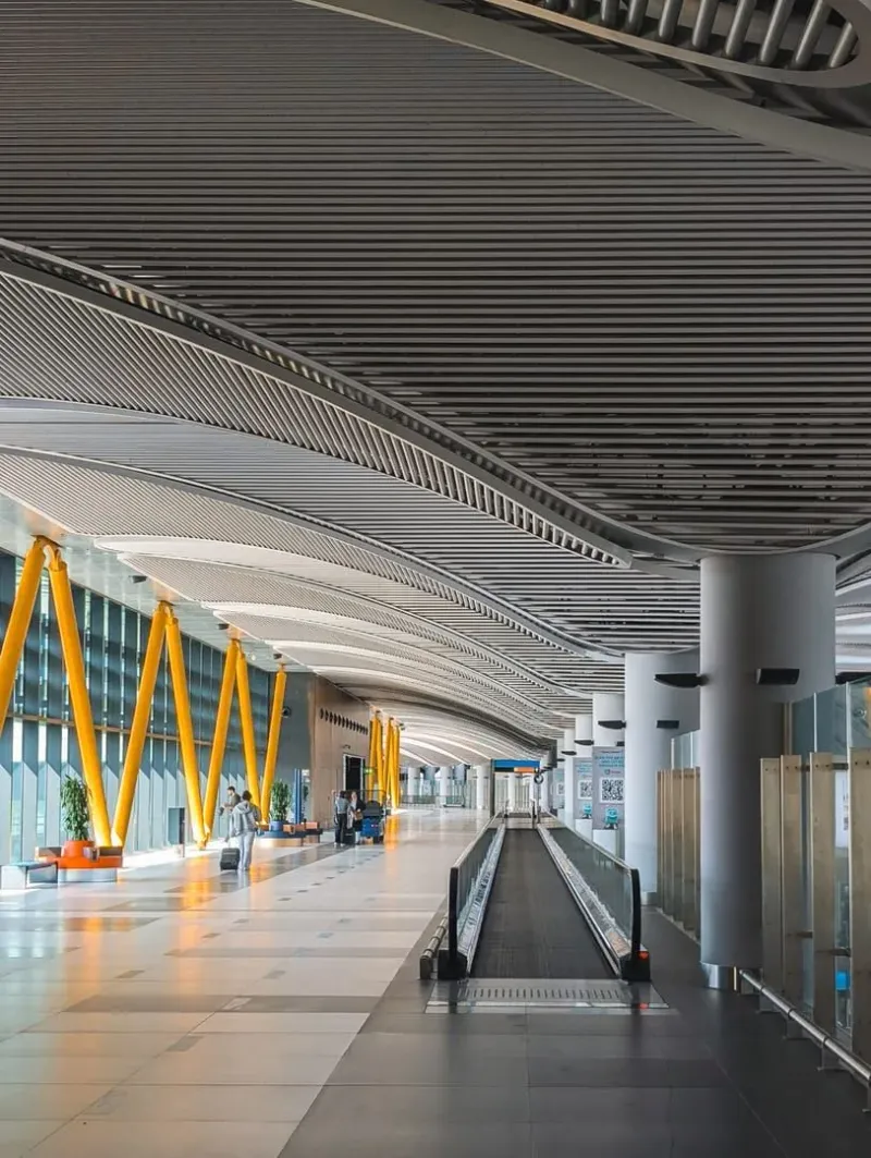 Bright modern airport terminal interior with high ceilings representing regional airport transfers