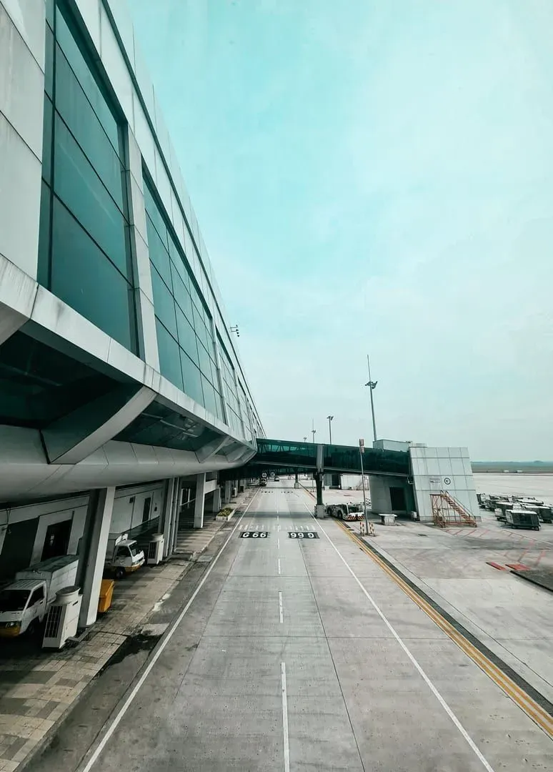 Empty terminal roadway under a clear sky near an island airport transfer zone
