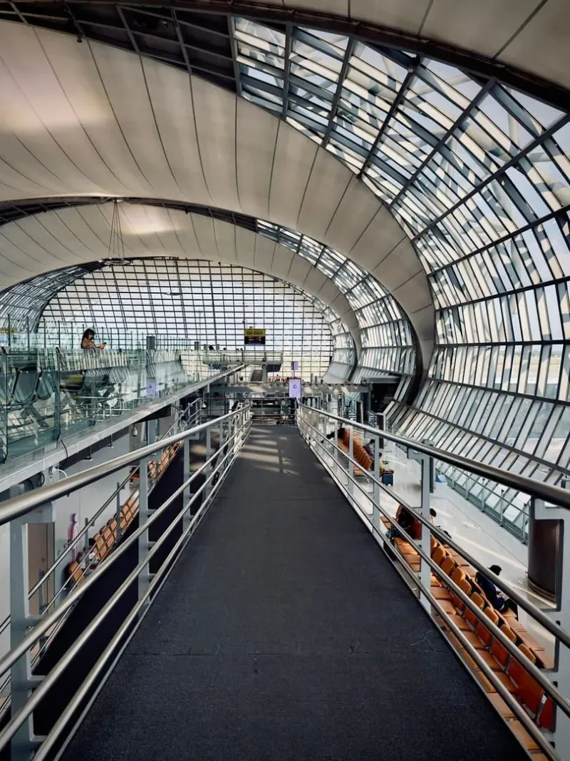 Glass and steel airport terminal interior representing a Bangkok Airways connecting hub to Samui