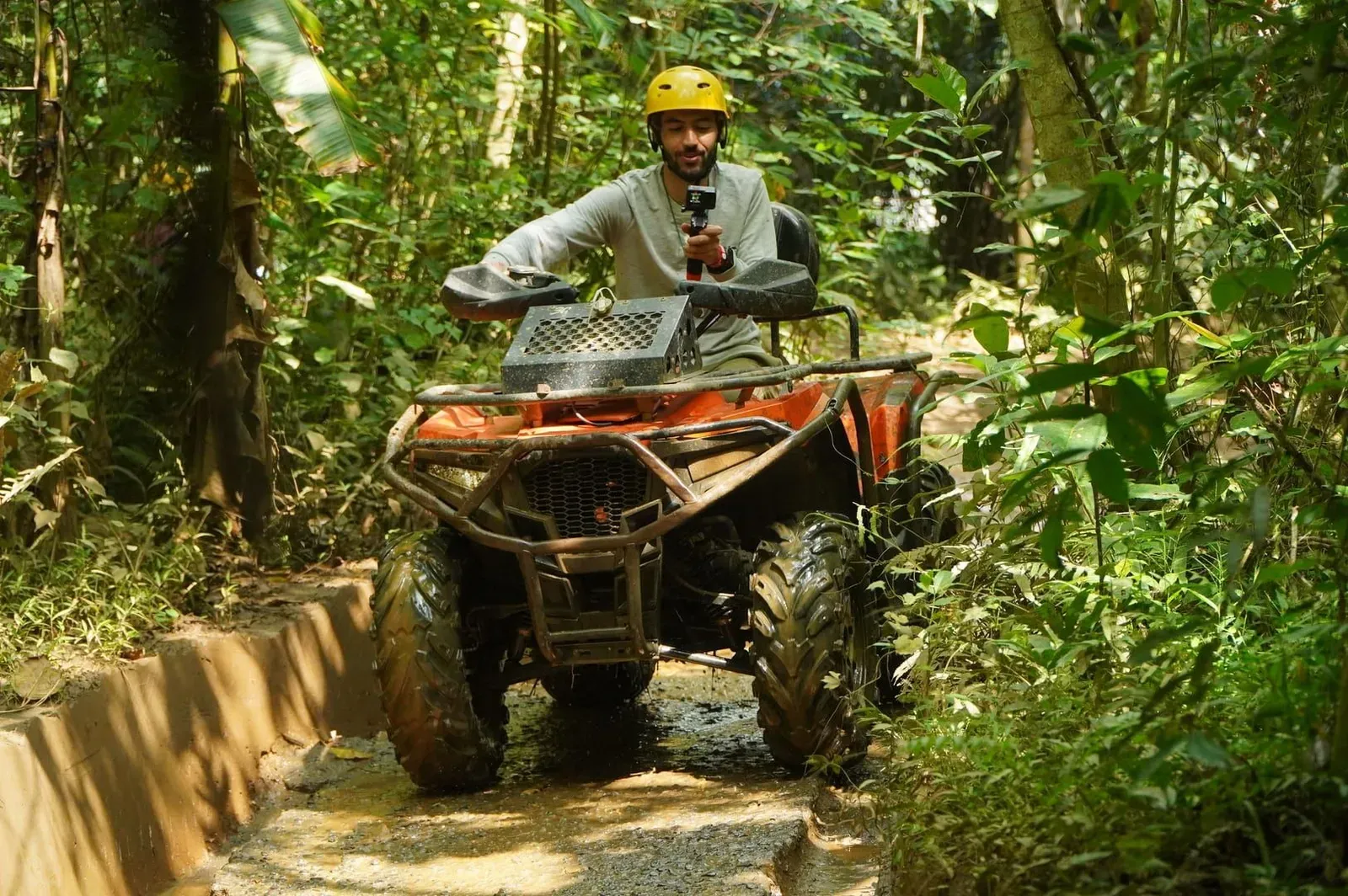 Rider in safety harness and helmet navigating a jungle ATV trail on Koh Samui