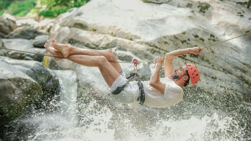 Zipline adventure crossing over a waterfall like the jungle courses near Koh Samui