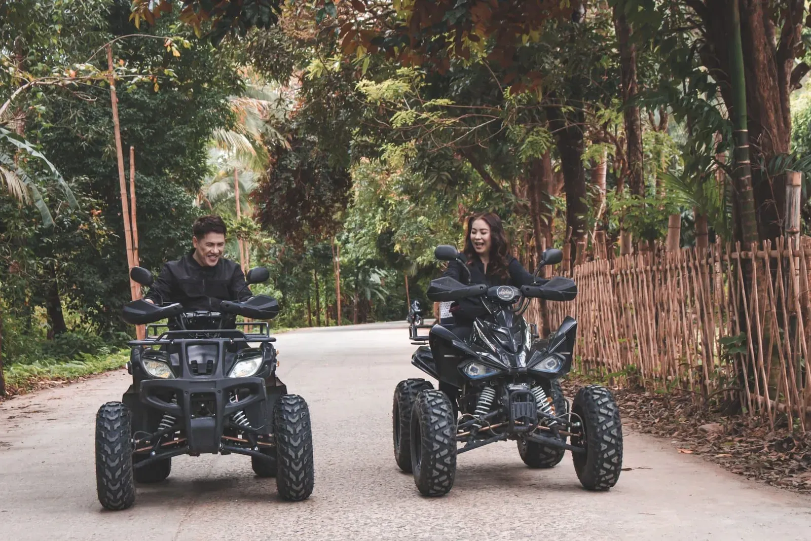 Two riders on quad bikes crossing rural terrain on a Koh Samui-style ATV adventure tour