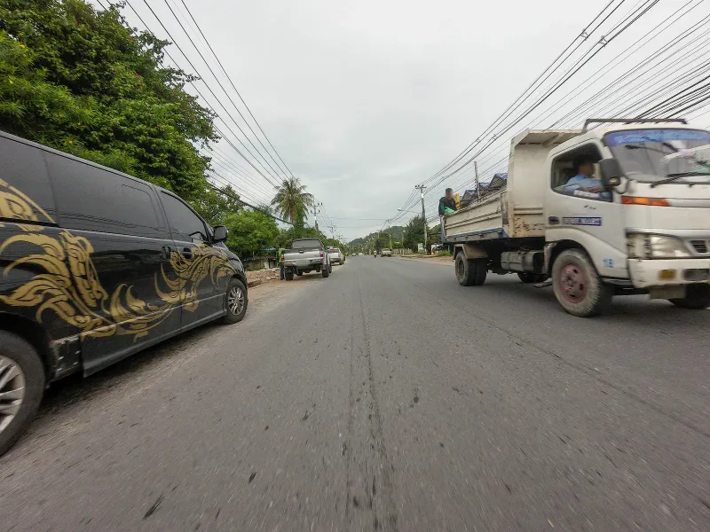 Ring road near Bang Po Seafood on Koh Samui's Maenam-Bang Po coast, lined with shops and palms