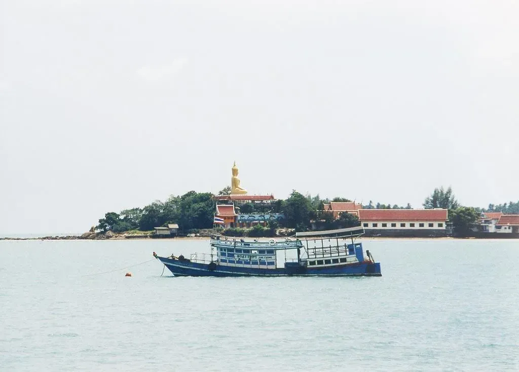 Golden Big Buddha statue at Wat Phra Yai temple on Koh Samui viewed from the causeway