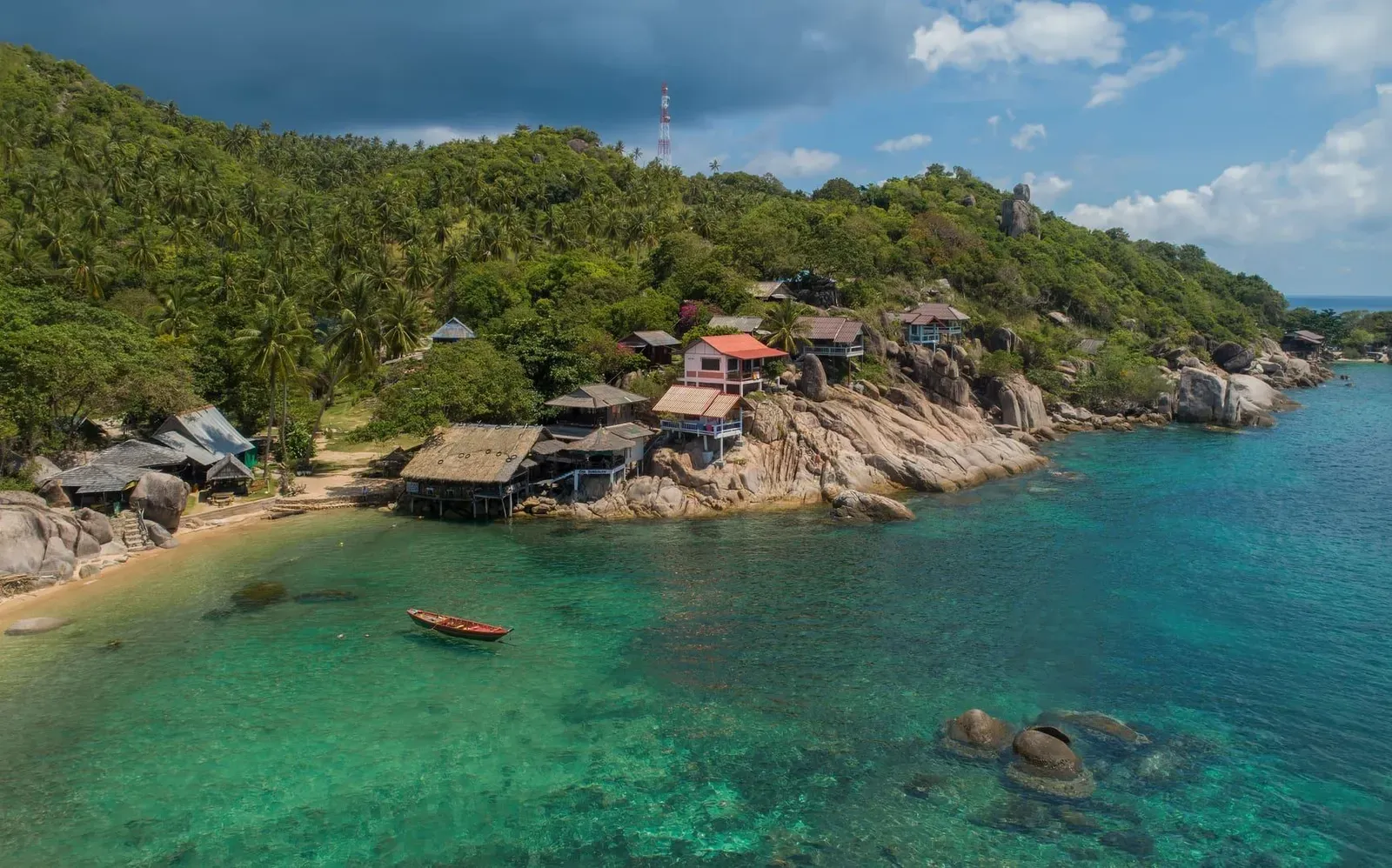 Aerial view of a Koh Samui coastal area with palm-lined sand and clear water typical of the island's accommodation zones