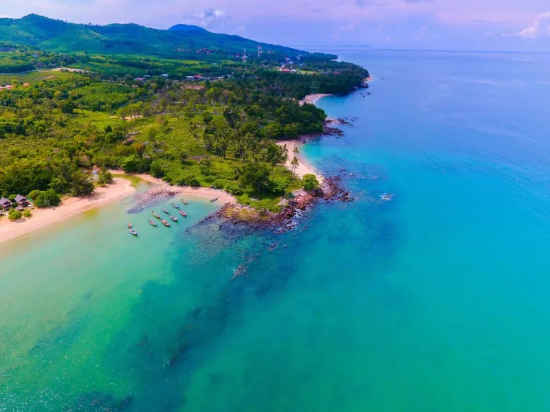 Aerial view of a tropical beach and green landscape near a Koh Samui resort area