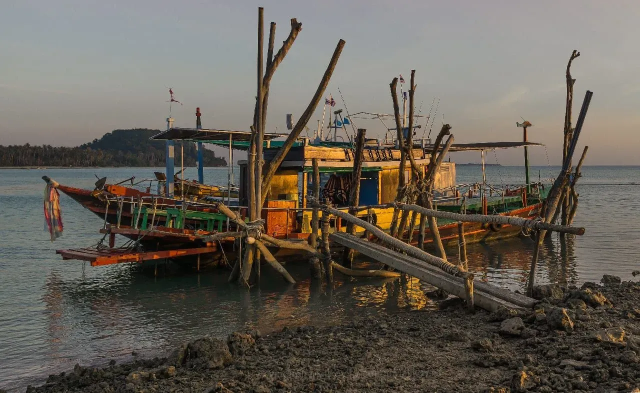 Longtail boat on calm water off Koh Samui at dusk, representing ferry and boat tour booking windows