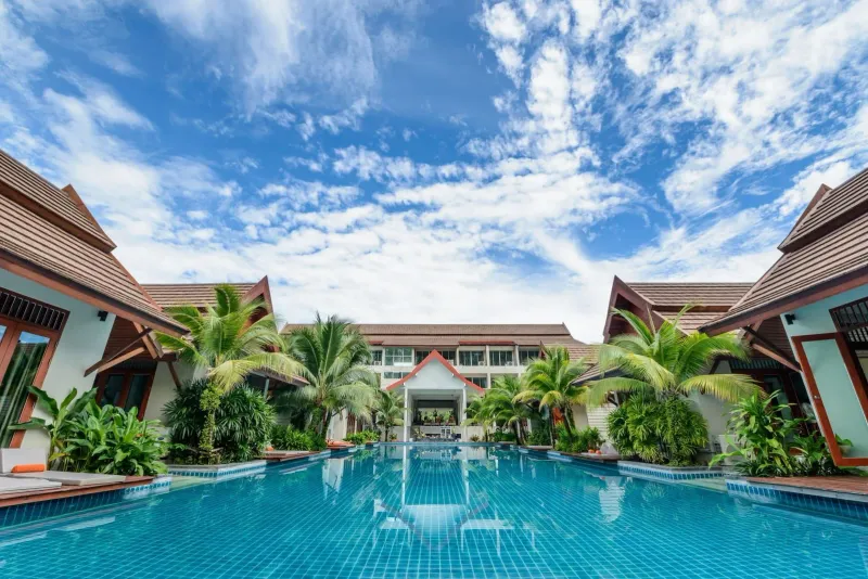 Spacious swimming pool surrounded by tropical villas at a Koh Samui boutique resort