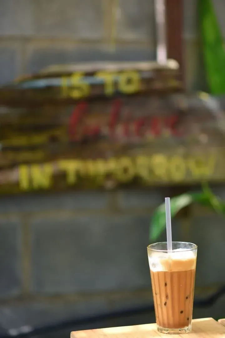 Glass of iced coffee at an outdoor cafe, a common laptop-friendly Koh Samui setup