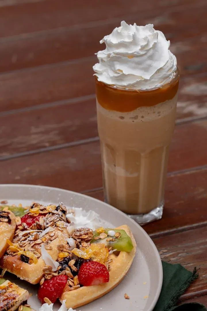 Waffles with fruit and iced coffee, a typical brunch plate served at Koh Samui beachfront cafes