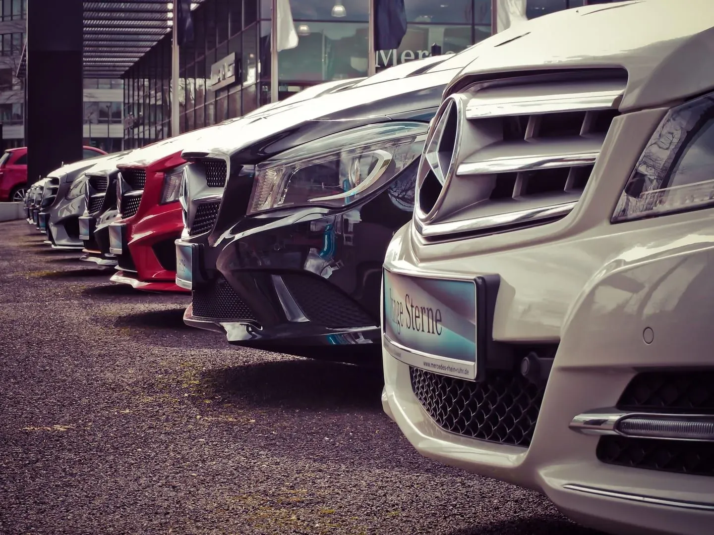 Row of rental-style cars parked outdoors, illustrating the range of vehicle classes available on Koh Samui
