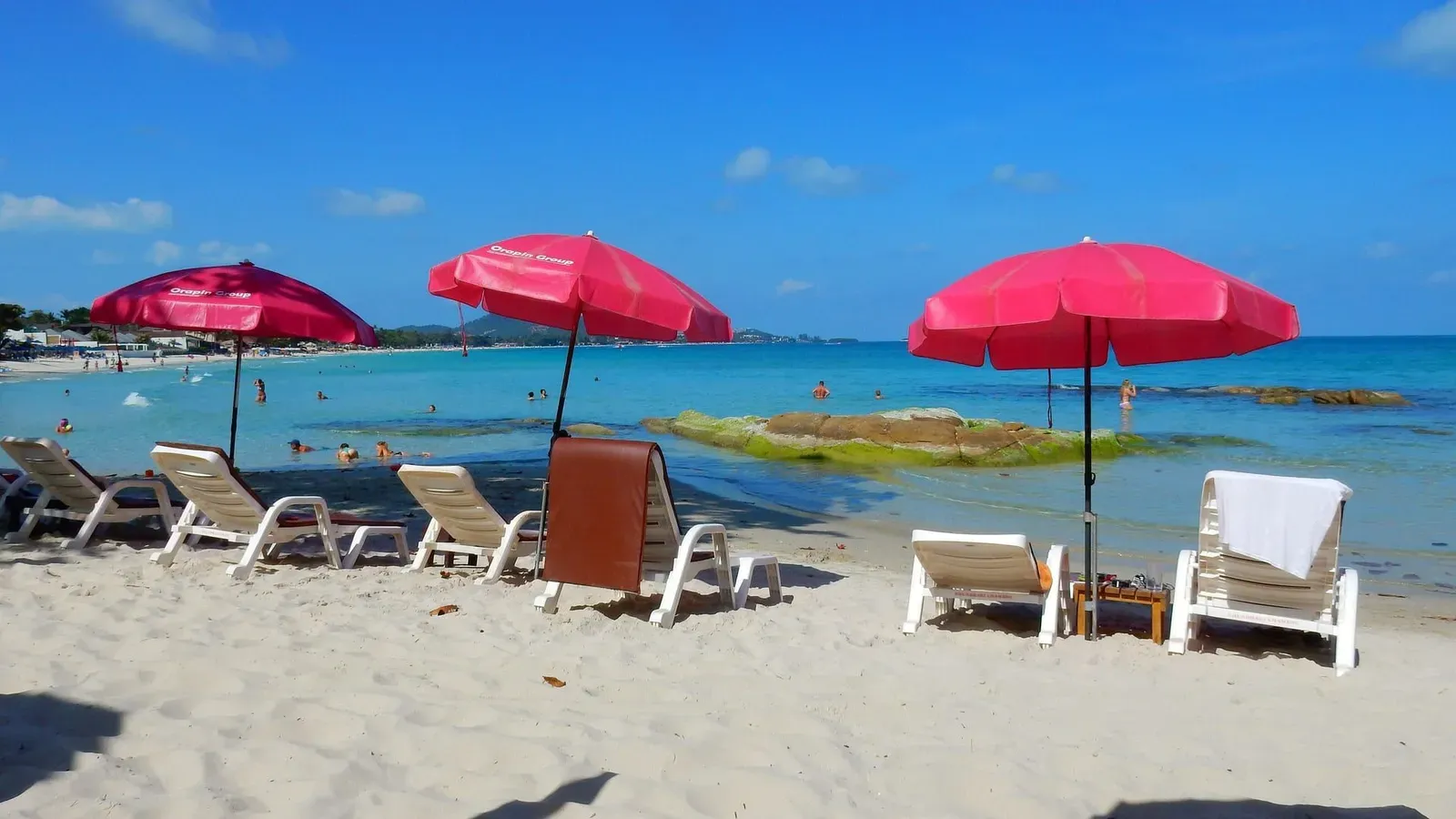 White sand beach and calm turquoise water along the Chaweng coastline on Koh Samui
