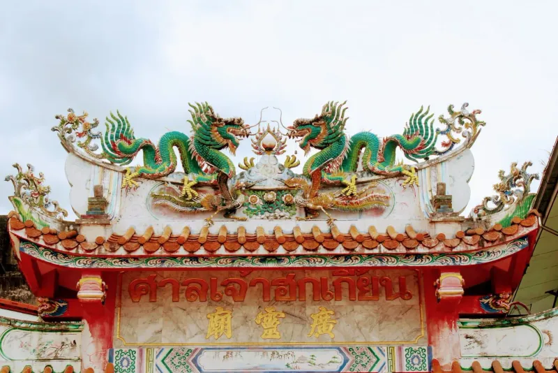 Detailed dragon rooftop sculpture on a Chinese temple, the style seen at Koh Samui's Hainanese shrines